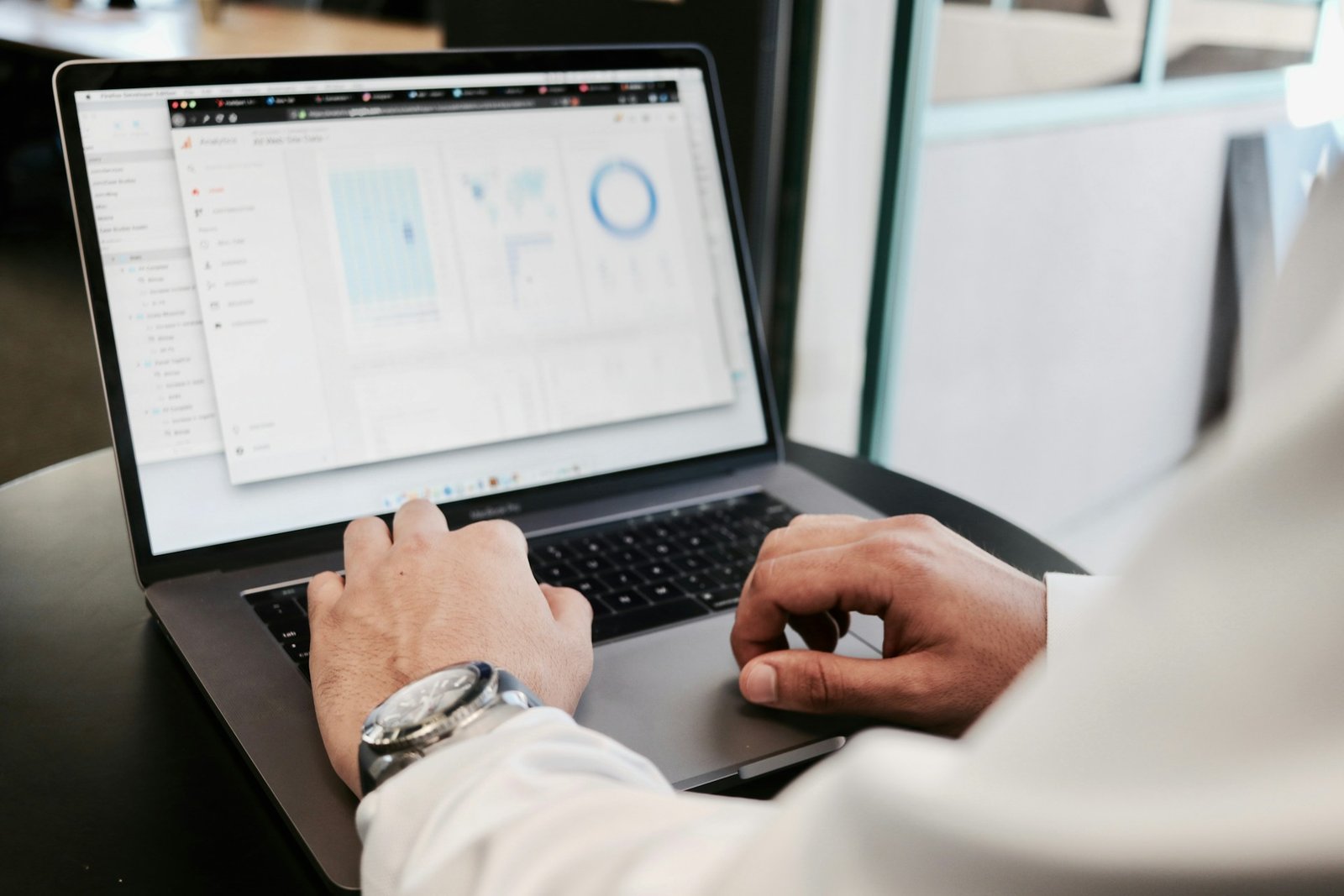 Person reviewing local SEO performance charts and search data on a laptop.